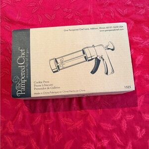 Pampered Chef cookie press in box with 16 disks